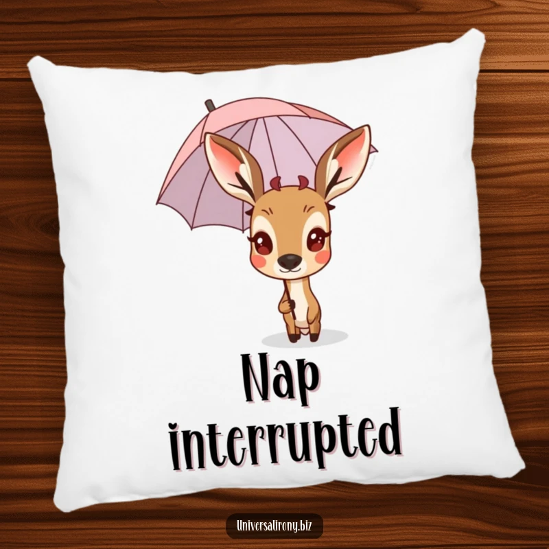 Funny surprised deer peeking from behind a tiny, upside-down umbrella on a plush pillow.