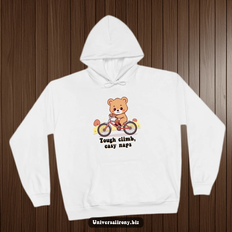 Funny hoodie depicting a cute, determined bear cub struggling mightily to ride a tiny bicycle up an incline, inspiring effort.