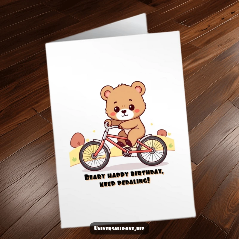 Funny Free Printable Birthday Card: Cute bear cub pedals a tiny bike uphill with great determination, a motivational and humorous design.