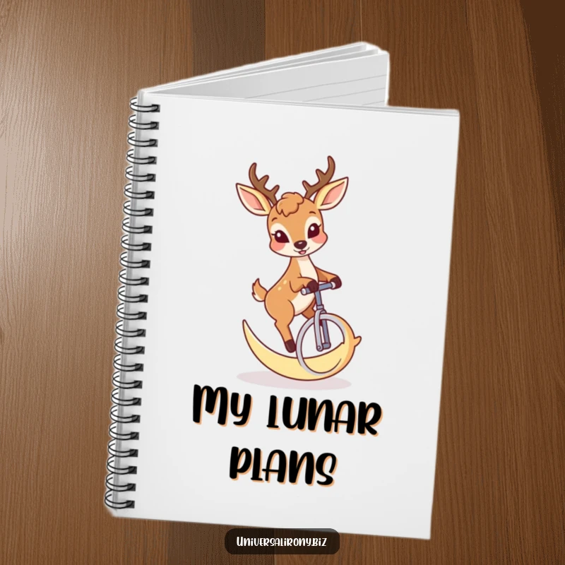 Notebook featuring a funny deer with a mischievous grin riding a crescent moon unicycle.