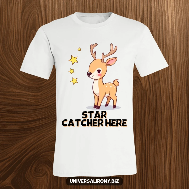 Funny playful deer attempting to juggle three small, twinkling stars on a whimsical t-shirt.